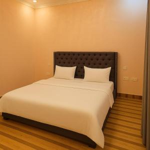 Ένα ή περισσότερα κρεβάτια σε δωμάτιο στο Amada Kigali Luxury Apartments