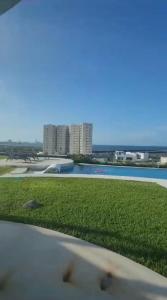 a view of a swimming pool with buildings in the background at Residencia de Novela in Conchal