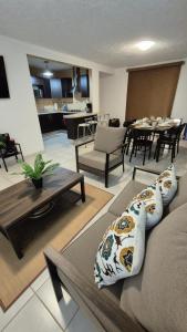a living room with two couches and a table at Marina Diamante Victory in Acapulco