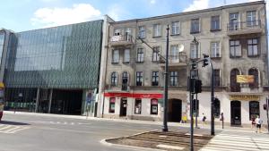an empty street in a city with a building at FRESCO PLUS -Filharmonia in Łódź