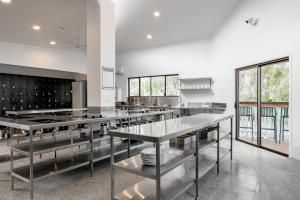 a large kitchen with stainless steel counter tops at Wake Up! Byron Bay in Byron Bay +51 photos