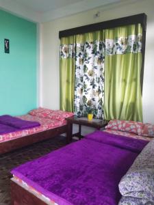 Ένα ή περισσότερα κρεβάτια σε δωμάτιο στο Neel DIGANTA HOME STAY, SILLERY GAON KALIMPONG
