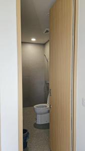 a bathroom with a toilet in a room at Seffa living bsd Jakarta in Cilenggang