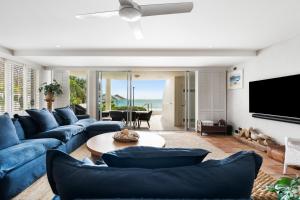 ヌーサヘッズにあるLa Mer Apartmentsのリビングルーム(青いソファ、テレビ付)