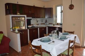 a kitchen with a table with plates and glasses on it at La Casa di Giulia in Forza dʼAgro