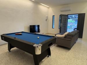 a room with a pool table and a couch at Lock homestay in Kulai