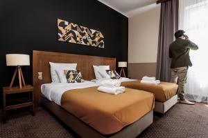 Ένα ή περισσότερα κρεβάτια σε δωμάτιο στο Zulian Aparthotel by Artery Hotels +33 φωτογραφίες