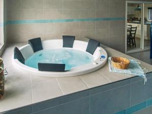 a bath tub in a bathroom with a hot tubificialificialificialificialificialificial at 18 person holiday home in Væggerløse in Marielyst