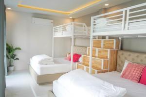 a bedroom with two bunk beds at Beloved Bliss Pool Villa Bangsaen in Chon Buri