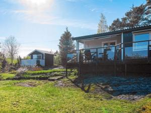 a home with a large deck and a house at 6 person holiday home in HENÅN in Henån