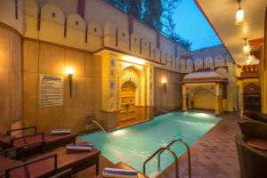 a large swimming pool in a building at Umaid Mahal - A Heritage Style Boutique Hotel in Jaipur