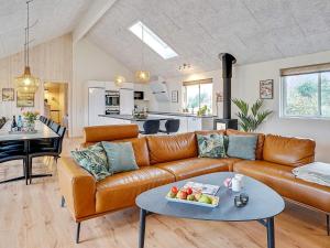 a living room with a couch and a table at 5 star holiday home in Grenaa in Grenå