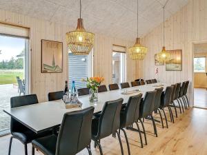 a large dining room with a long table and chairs at 5 star holiday home in Grenaa in Grenå +35 photos