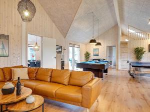 a living room with a couch and a pool table at Luxury Retreat near Grena - By Traum Ferienwohnungen in Grenå +33 photos