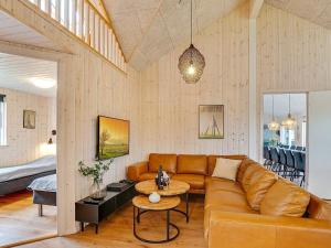 a living room with a couch and a table at 5 star holiday home in Grenaa in Grenå