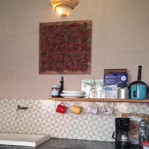 a kitchen counter with a shelf with dishes on it at Habitación frente al mar y alberca in Lerma