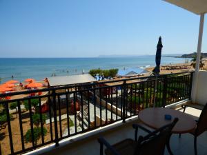 a balcony with a view of a beach and the ocean at Camelia Studios & Apartments in Stalos
