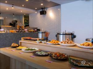 a buffet line with many different types of food at Daiwa Roynet Hotel Oita in Oita