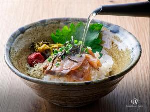 a bowl of rice and meat with a fork in it at Daiwa Roynet Hotel Oita in Oita