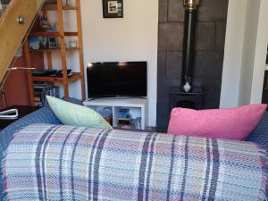 a living room with a couch and a tv at The Sidings in Matlock