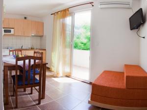 a room with a kitchen and a table and a dining room at Apartment Sangaleti in Lastovo