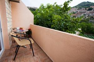 a small table and chair on a balcony with a view at Apartment Sangaleti in Lastovo