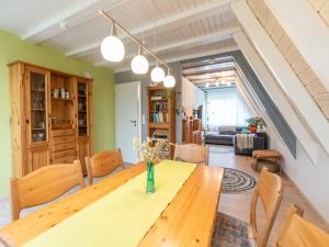 a dining room with a wooden table and chairs at Holiday home in Bestwig with private garden in Bestwig