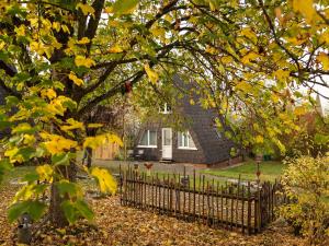 a house with a fence in front of it at Ferienhaus in Bestwig mit privatem Garten in Bestwig