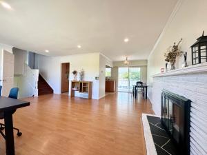 a living room with a fireplace and a dining room at Spacious 4 Bedroom House Near YVR Airport, Transit & Shopping in Richmond