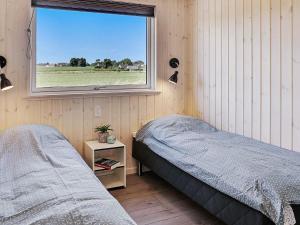 a bedroom with two beds and a window at 5 star holiday home in Stege in Stege