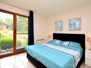 a bedroom with a bed and a large window at Beautiful Holiday Home in Durbuy with Garden in Septon