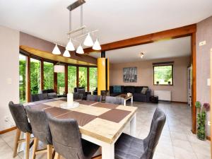 a dining room and living room with a table and chairs at Beautiful Holiday Home in Durbuy with Garden in Septon