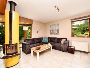 a living room with a couch and a fireplace at Beautiful Holiday Home in Durbuy with Garden in Septon