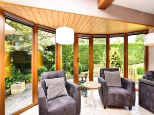 a living room with two chairs and a table at Beautiful Holiday Home in Durbuy with Garden in Septon