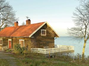 an old house sitting on the side of the water at 6 person holiday home in HOVA-By Traum in Hova