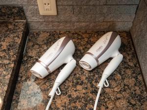 two white game controllers sitting on the floor at East Nagoya Entire 3-Story House in Nagoya