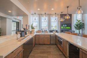 a large kitchen with wooden cabinets and a large island at Scottsdale Stay , Steps from Westin Kierland, Pool & Parking- N390 in Scottsdale
