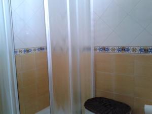a bathroom with a shower with a toilet and a tub at Villino Messina in San Vito lo Capo