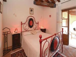 a bedroom with a bed with a metal frame at Villa in Montalbano with Scenic Views in Città di Castello