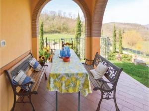 a patio with a table and two benches on a patio at Villa in Montalbano with Scenic Views in Città di Castello