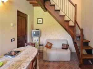 a living room with a staircase and a white couch at Villa in Montalbano with Scenic Views in Città di Castello +32 photos