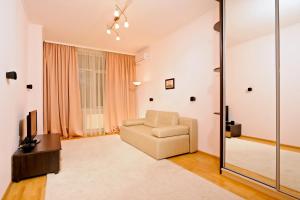 a living room with a chair and a sliding glass door at Lukyanovsky in Kyiv