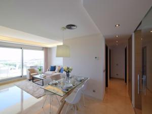 a dining room and living room with a table and chairs at Cozy Golf Retreat Costa del Sol in Sitio de Calahonda +14 photos