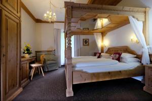 a bedroom with a canopy bed in a room at Hotel Evaldo in Arabba +65 photos