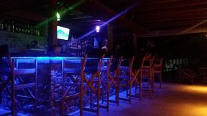 a bar with a bunch of chairs in a room at Hotel Zachos in Troulos