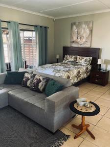 a living room with a bed and a couch at Willow Cottage in Evander