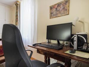 a desk with a computer monitor and a chair at Cottage in an old remote farmhouse in Giroux