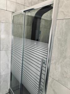 a glass shower door with a window in a bathroom at Willow Cottage in Evander +43 photos