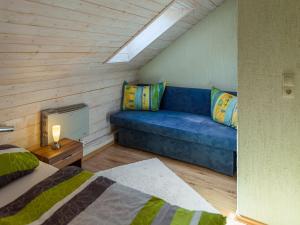 a living room with a blue couch in a room at Apartment near Rennsteig in Goldisthal