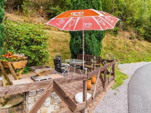 a patio with a table and an umbrella at Apartment near Rennsteig in Goldisthal